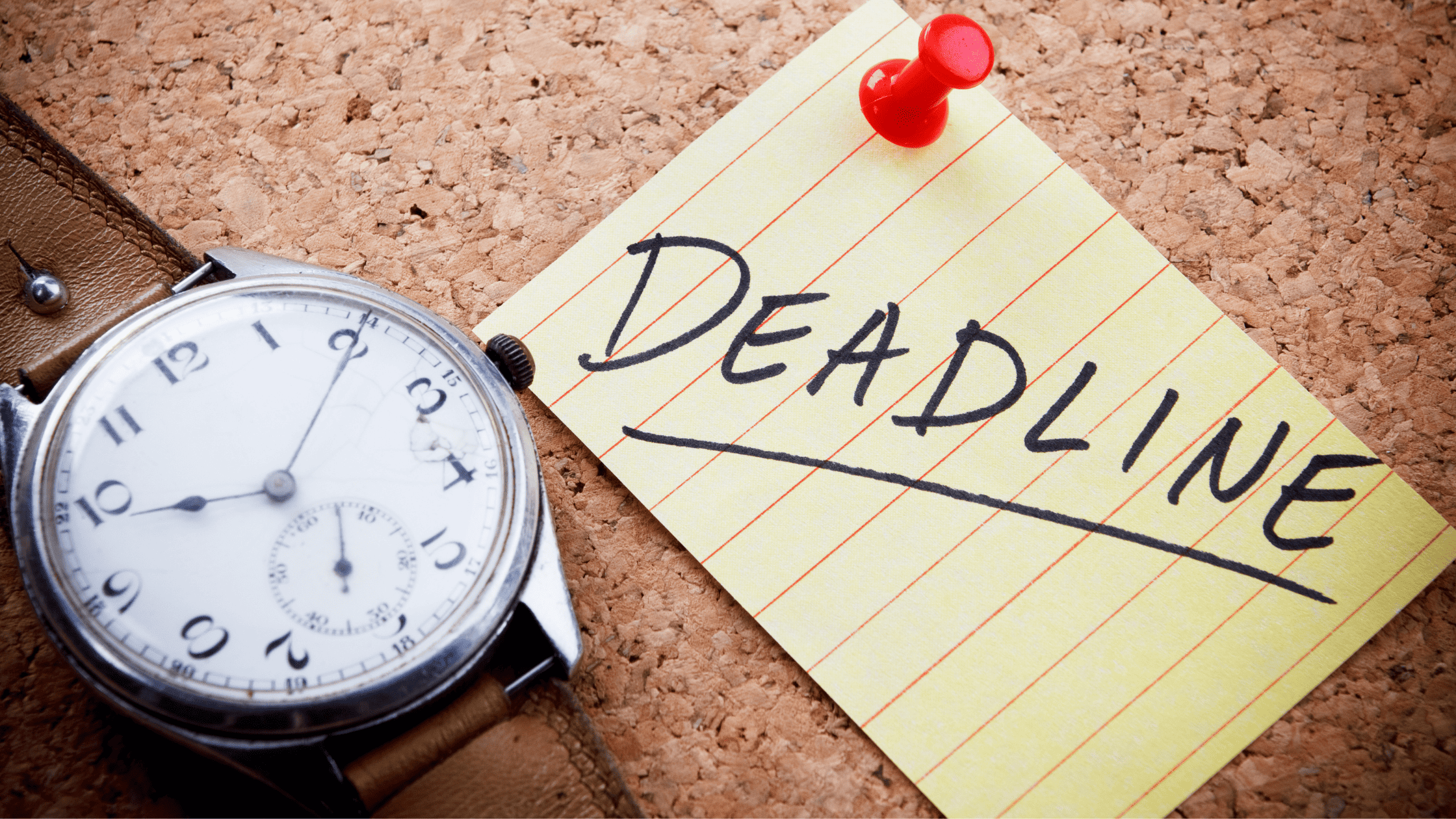 A note on a cork board with the word deadline