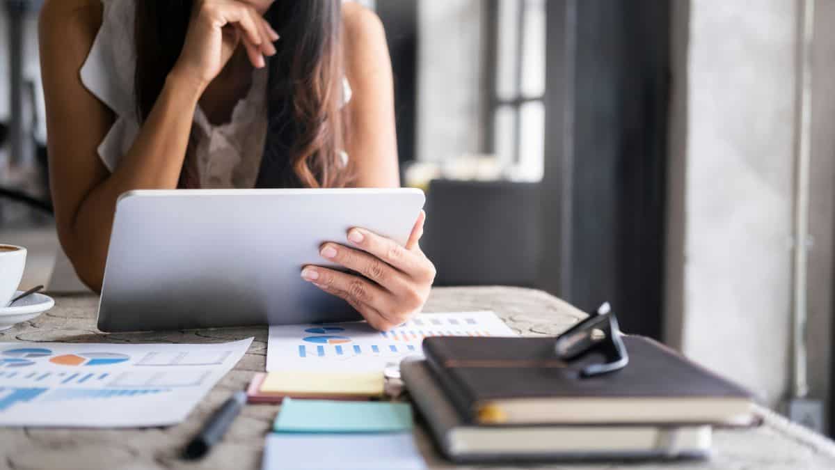 A photo of a woman holding a tablet