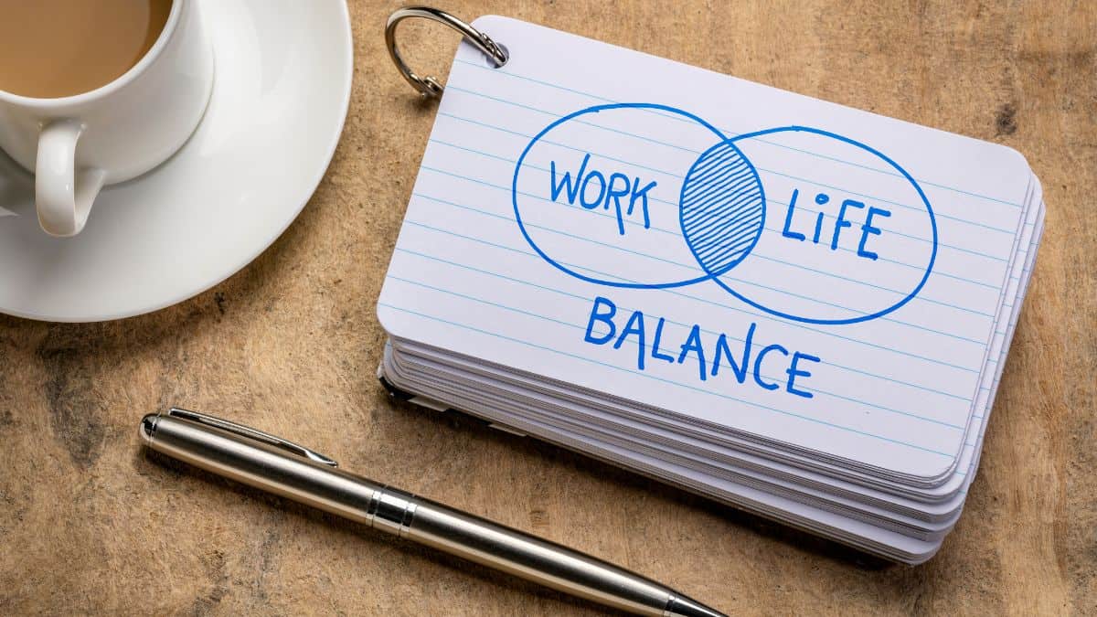 A photo of a coffee, pen, and stack of index card with the word “work life balance” written on it