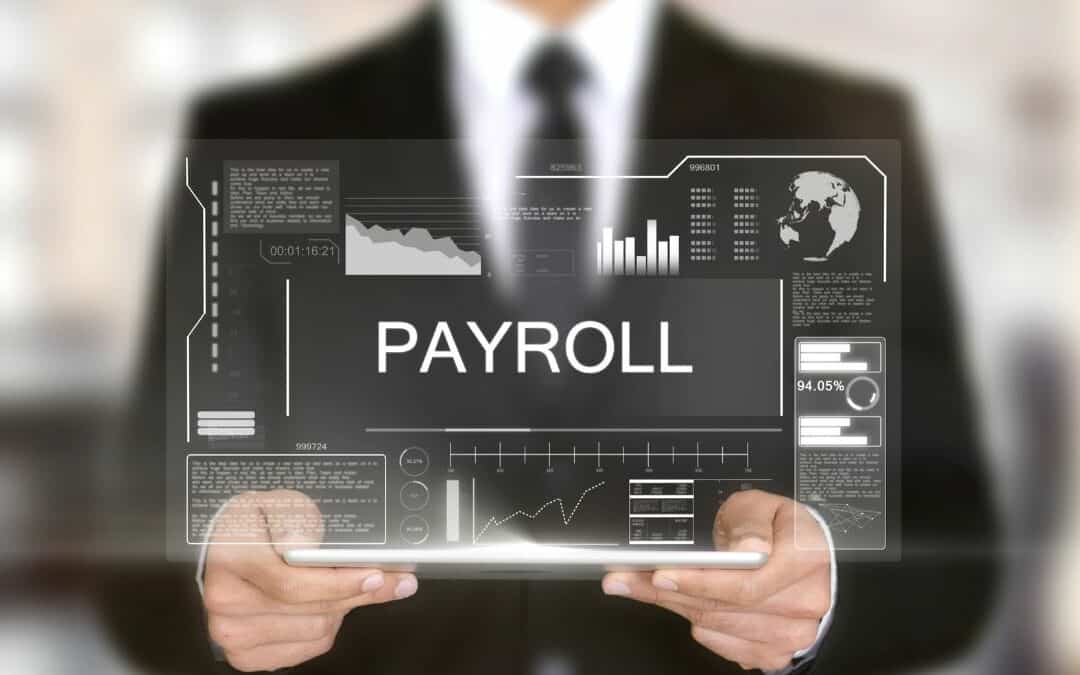 A photo of a man holding a hologram of the word payroll with figures and graphs