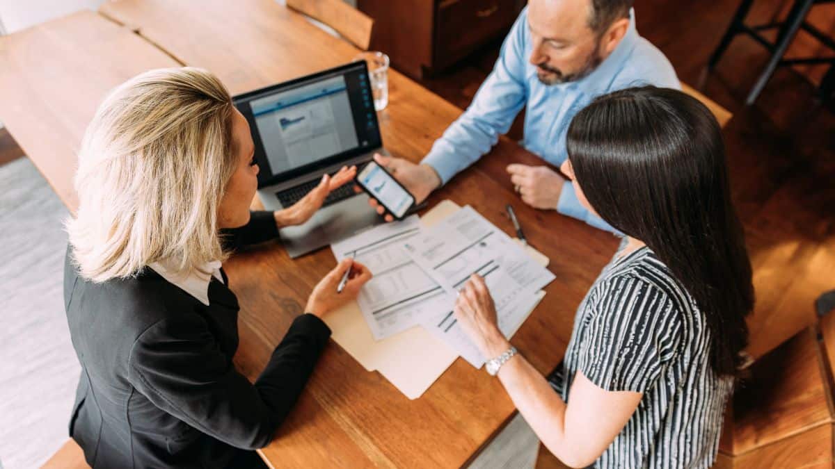 A photo of three people working together